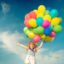 Happy child jumping with colorful toy balloons