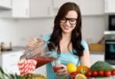 Happy young woman pouring vegetable smoothies