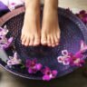 Female feet at spa pedicure procedure